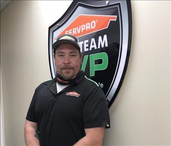  A man standing in front of a SERVPRO sign